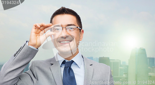 Image of happy smiling businessman in eyeglasses and suit