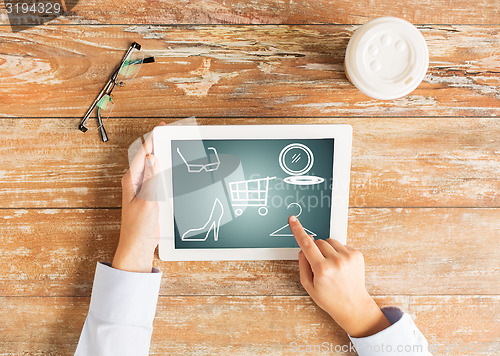 Image of close up of female hands with tablet pc and coffee