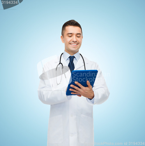 Image of smiling male doctor in white coat with tablet pc