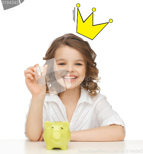 Image of smiling girl with piggy bank and euro coin