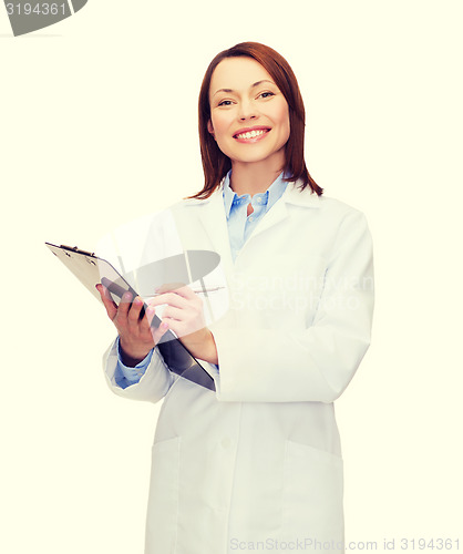 Image of smiling female doctor with clipboard