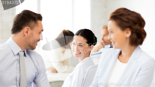 Image of business team discussing something in office