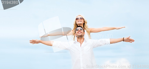 Image of couple holding hands up at sea side