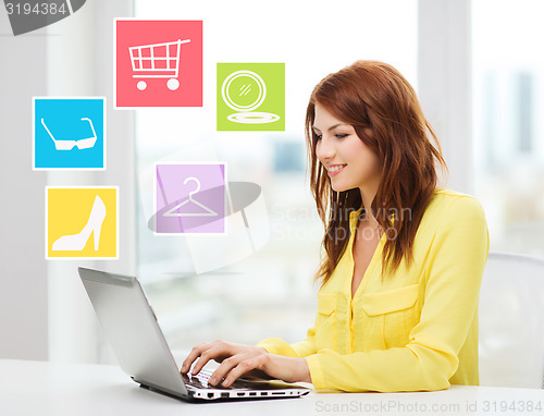 Image of smiling woman with laptop shopping online at home