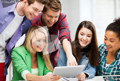 Image of students looking at tablet pc in lecture at school