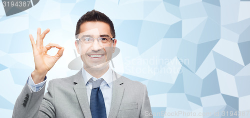 Image of happy smiling businessman in eyeglasses and suit