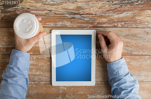 Image of close up of male hands with tablet pc and coffee