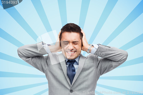 Image of businessman in suit having head ache