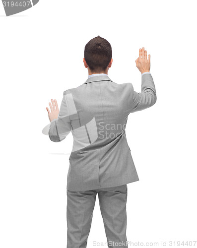 Image of businessman touching something imaginary