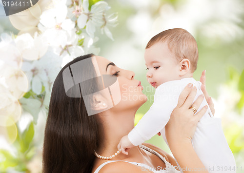 Image of happy laughing baby playing with mother