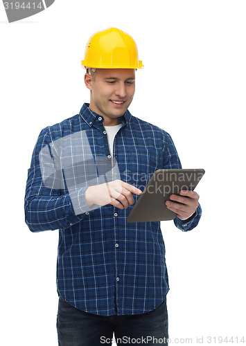 Image of smiling male builder in helmet with tablet pc