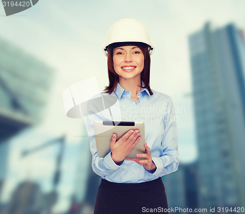 Image of young smiling businesswoman in white helmet