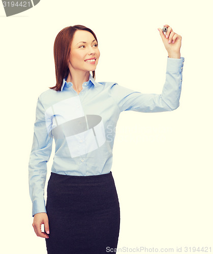 Image of businesswoman writing something in air with marker