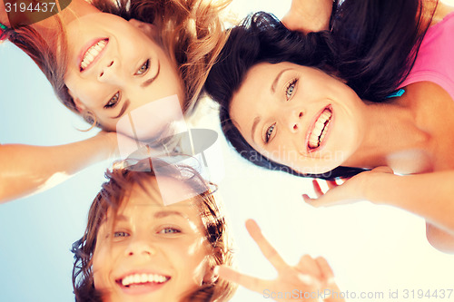 Image of girls faces with shades looking down