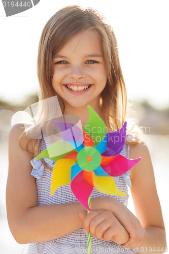 Image of happy girl with colorful pinwheel toy