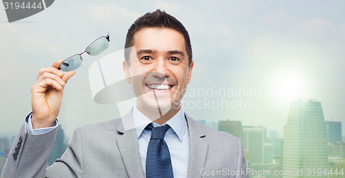 Image of happy smiling businessman in eyeglasses and suit