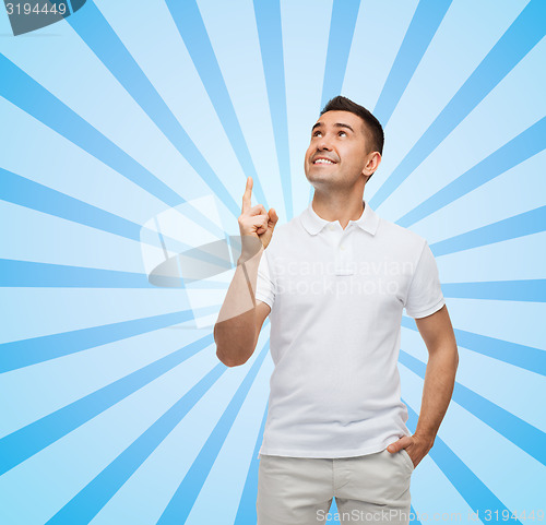 Image of smiling man pointing finger up