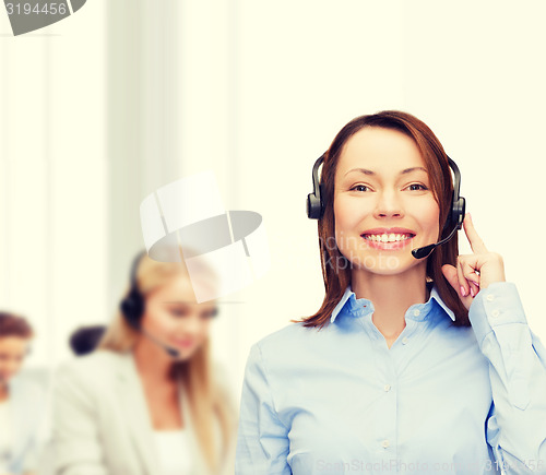 Image of friendly female helpline operator at office