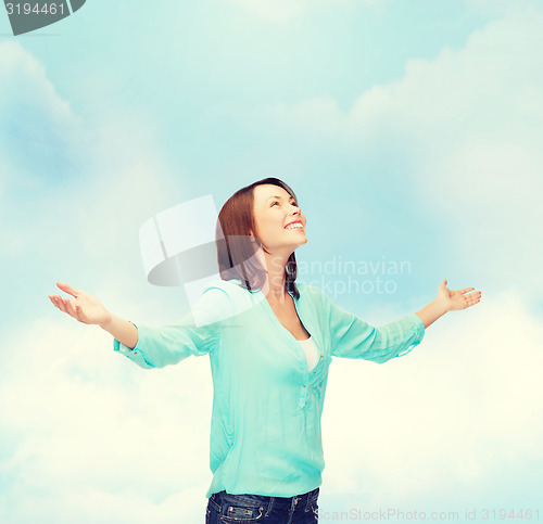 Image of smiling woman waving hands