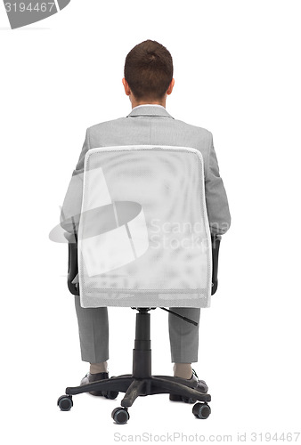 Image of businessman sitting in office chair from back