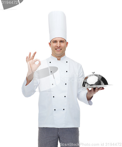 Image of happy male chef cook with cloche showing ok sign