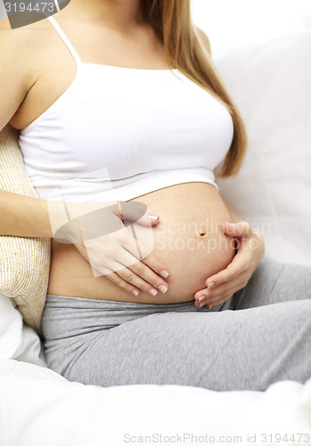 Image of close up of happy pregnant woman at home