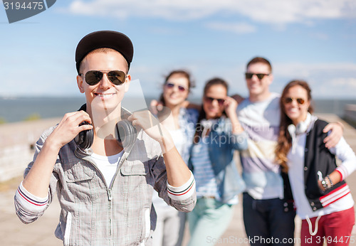 Image of teenage boy with sunglasses and friends outside