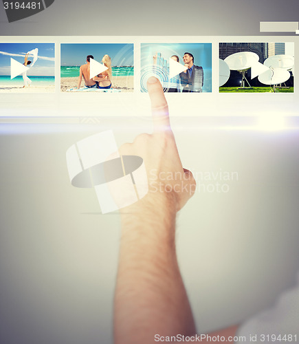 Image of man pressing button on virtual screen
