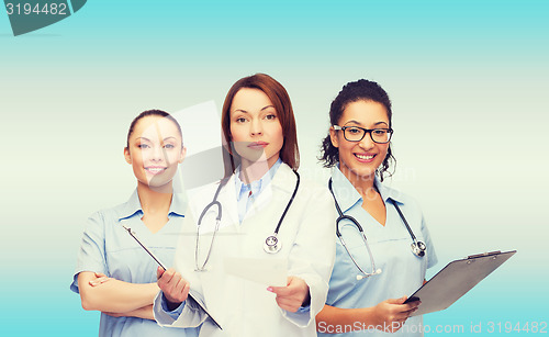 Image of calm female doctor with clipboard