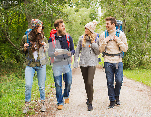 Image of group of smiling friends with backpacks hiking