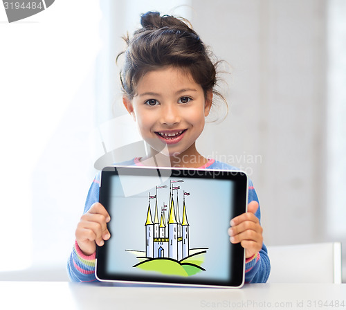 Image of little girl showing castle on tablet pc screen