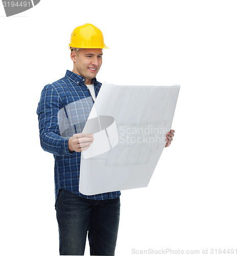 Image of smiling male builder in helmet with blueprint