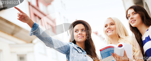 Image of beautiful girls looking for direction in the city