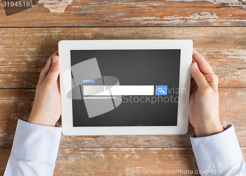 Image of close up of male hands using browser on tablet pc