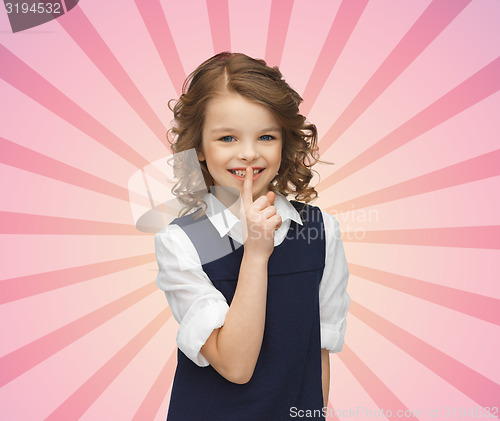 Image of happy girl showing hush gesture