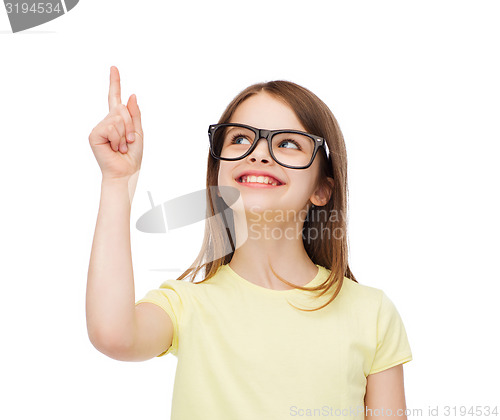 Image of smiling cute little girl in black eyeglasses