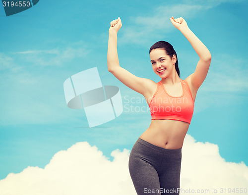 Image of smiling teenage girl in sportswear dancing