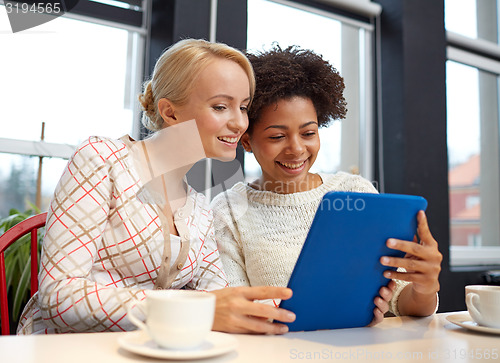 Image of happy young women drinking tea or coffee at cafe