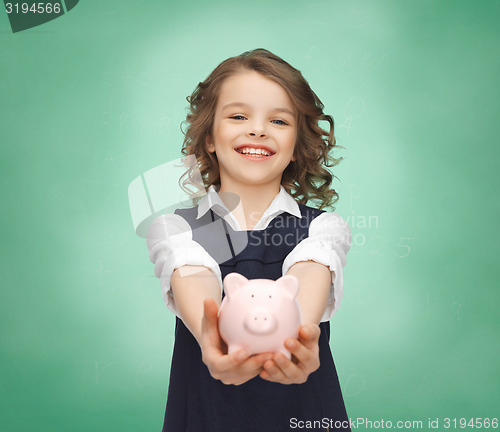 Image of happy girl holding piggy bank on palms