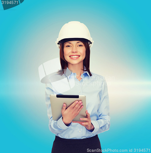 Image of young smiling businesswoman in white helmet