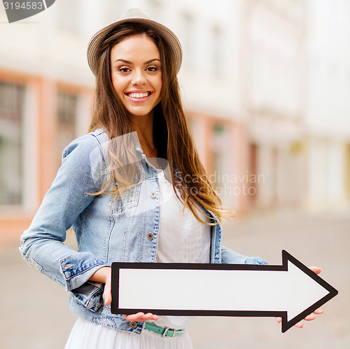 Image of girl showing direction with arrow in the city