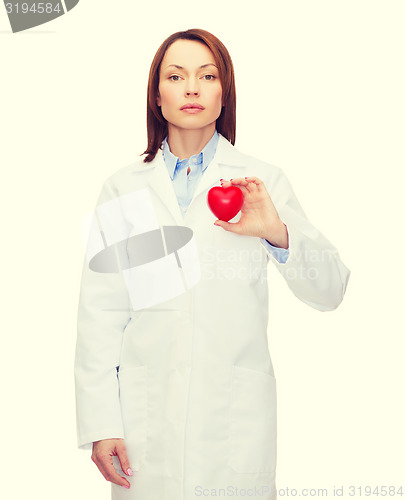 Image of serious female doctor with heart