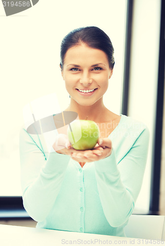 Image of lovely housewife with green apple