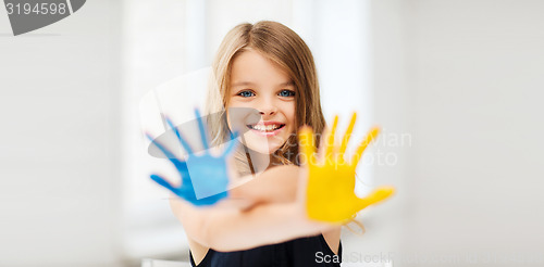 Image of girl showing painted hands