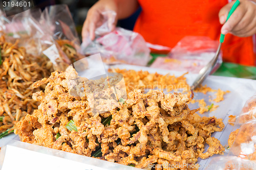 Image of close up of cook hands and snacks at street market