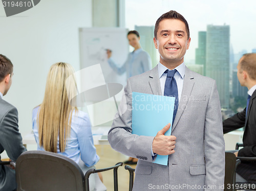 Image of happy businessman with open folder