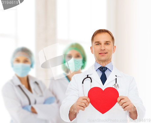 Image of smiling male doctor with red heart and stethoscope