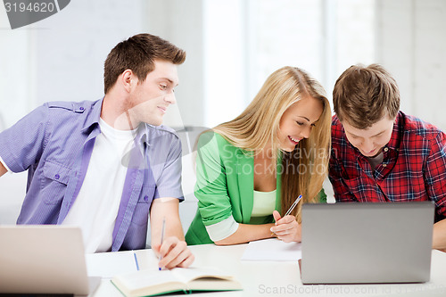 Image of students writing something at school