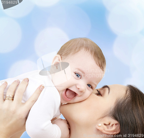 Image of laughing baby playing with mother