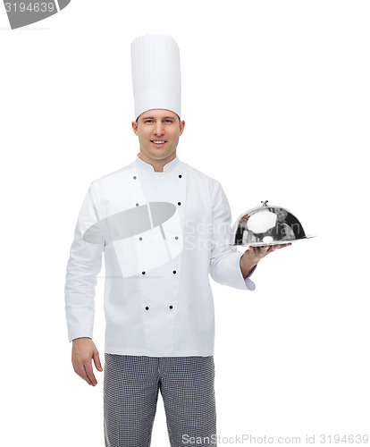 Image of happy male chef cook holding cloche